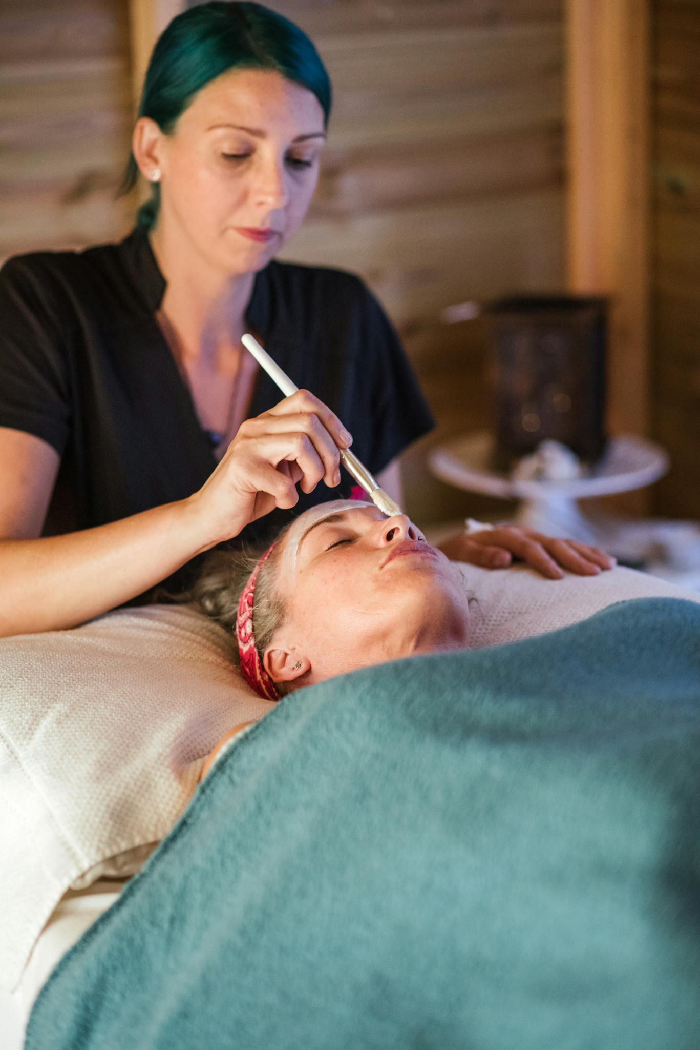 Woman receives soothing facial treatment in serene spa environment promoting relaxation and rejuvenation.